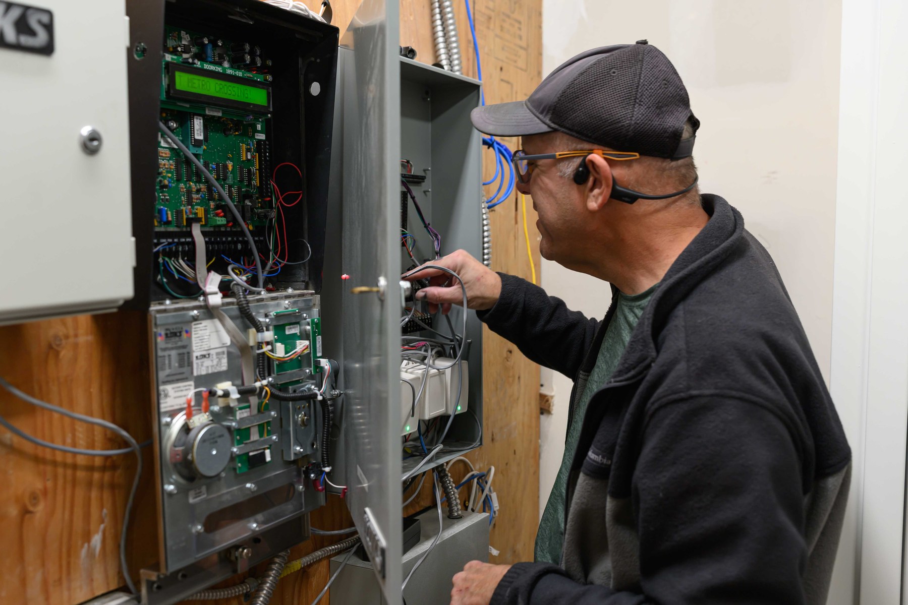 Technician inspecting access control wiring